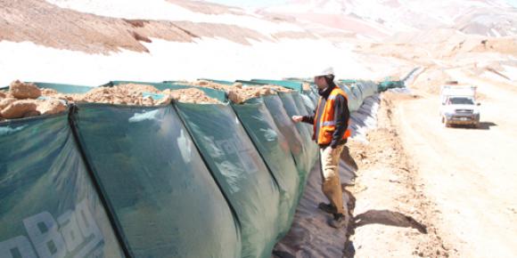 Man next to spill control barrier in San Juan, Argentina