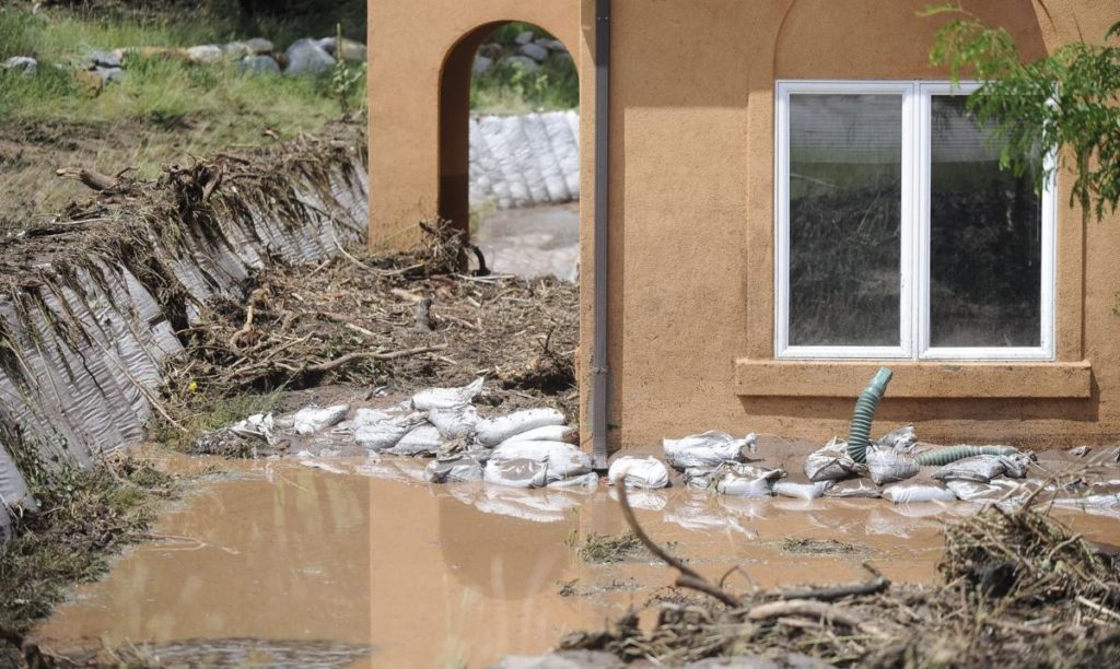 mud overpowering sandbags around a home